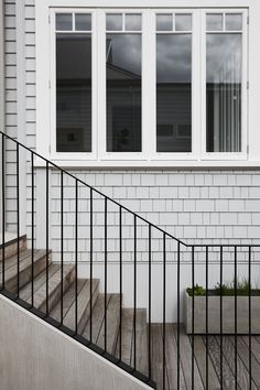 a black and white stair case next to a window