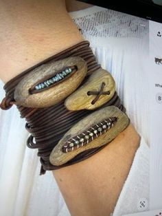 a woman's arm with two bracelets made out of wood and metal beads