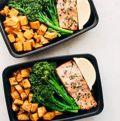 two black trays filled with broccoli, tofu and sweet potato wedges