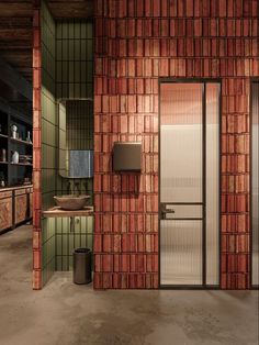 the interior of a bathroom with brick walls and glass doors that lead to an outdoor shower