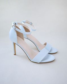 Classic satin high heel sandals adorned with ankle strap for romantic, elegant and feminine look. The light blue color can easily be your something blue. Simple and easy wear for bridal wear, bridesmaids, holiday party, wedding parties, and any special occasions. DETAILS:HEEL HEIGHT: 3.5 InchesCOLORS AVAILABLE: Ivory, Light Blue, Champagne, White, FuchsiaUPPER: Synthetic upper and liningMATERIALS: Manmade outsole STYLE NAME: DEMI Blue Wedding Shoe, Light Blue Wedding Shoes, Blue Wedding Shoes, Bridal Flats, Flower Girl Shoes, Wedding Shoes Bride, Satin Shoes, Bridal Heels, Glitter Heels