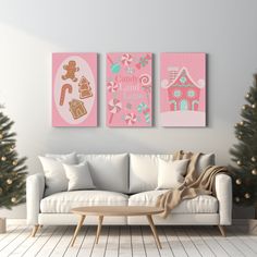 two paintings on the wall above a couch in a living room with christmas trees and other decorations