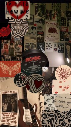 a wall covered with posters and guitars