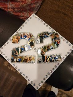 a white graduation cap decorated with pictures of people and letters that spell out the letter e