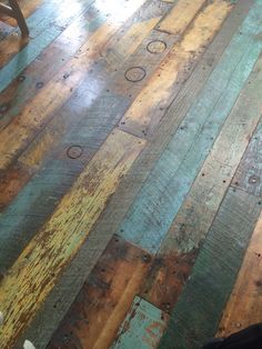 an old wooden floor with peeling paint on it