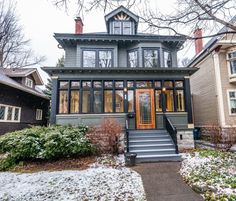 a house is shown in the winter with snow on the ground and trees around it