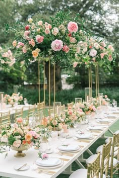 a long table with flowers and plates on it