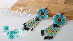 the earrings are made with seed beads and beaded in black, white, and blue colors