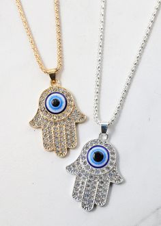 shimmery, rhinestone hamsa hand + evil eye necklace comes with an adjustable chain clasp for easy and a comfortable wear comes in both gold and silver Hamsa Hand Necklace, Hand Evil Eye, Hand Necklace, Evil Eye Necklace, Earrings Rings, Hamsa Hand, Eye Necklace, Trendy Jewelry, Gold And Silver