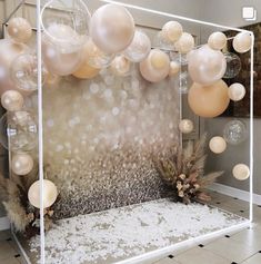 a room with balloons and decorations on the wall in front of an open area for people to sit down