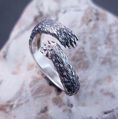 a silver ring sitting on top of a rock