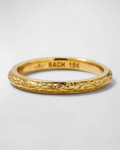 a yellow gold wedding band that has been engraved with the name bach 18k on it