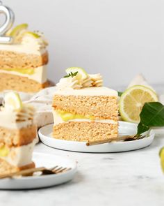 two slices of cake on plates with lemons and lime wedges next to them