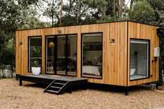 a small wooden cabin with sliding glass doors