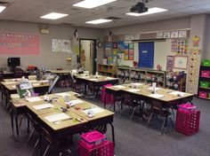 an empty classroom with many desks and boxes on the floor in front of them