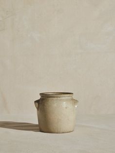 a white vase sitting on top of a table