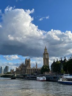 the big ben clock tower towering over the city of london on a partly cloudy day