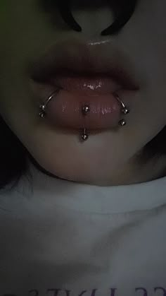 a woman with piercings on her nose