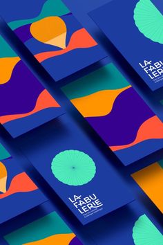 several business cards with colorful designs on the front and back cover, all in different colors