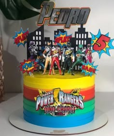 a birthday cake decorated with the power rangers characters on top of it, and surrounded by other decorations