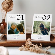 two wedding table numbers with pictures on them