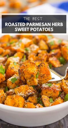 roasted parmesan herb sweet potatoes in a white bowl with a serving spoon on the side