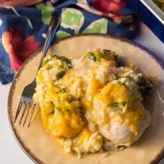 a close up of a plate of food with broccoli and cheese on it