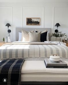 a bedroom with white walls and black accents