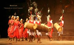 a group of people that are standing on a stage with some drums and drum sticks