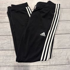 Women’s Adidas Jogger Style Sweatpants Size M Color Black Euc (Washed But Never Worn) Fabric: 100% Polyster Women’s Sweatpants Adidas, Adidas Stretch Pants With Three Stripes, Adidas Black Bottoms With Side Stripes, Fitted Adidas Pants With Three Stripes Branding, Black Joggers With Three Stripes, Adidas Three Stripes Pants For Loungewear, Adidas Three Stripes Loungewear Pants, Adidas Loungewear Pants With Three Stripes, Adidas Fitted Sweatpants