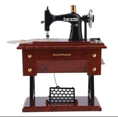 an old sewing machine is sitting on top of a wooden table with a basket underneath it