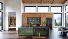 a large kitchen with wooden cabinets and black counter tops, along with lots of windows