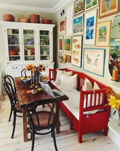 a living room filled with lots of furniture and pictures on the wall above it's table