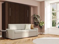 a living room with pink walls and white furniture in the corner, along with potted plants