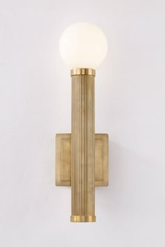 a wall light with a white glass ball on it