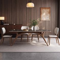 a dining room table and chairs in front of a wooden wall with an art work on it