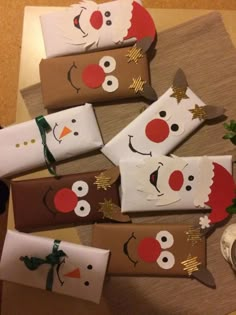 paper wrapped in brown and white with snowmen on them, sitting on a table