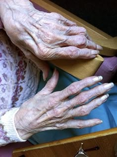 an older woman's hands resting on her lap