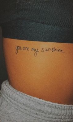 the back of a woman's stomach with an inscription on it that says, you are my sunshine