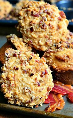 some cookies are sitting on top of each other in a baking pan with dried fruit and nuts