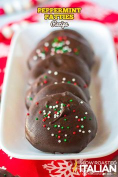 chocolate peppermint patties with sprinkles in a white dish on a red tablecloth