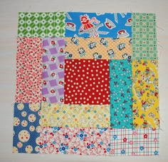 a patchwork quilt with different colors and patterns