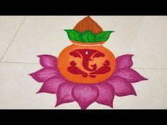 an orange pot sitting on top of a purple flower with the letter j painted on it