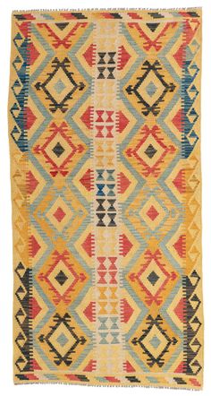 a multicolored kilim rug with diamond shapes on the front and back sides