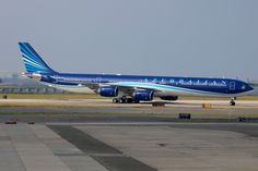 a blue and white airplane is on the runway