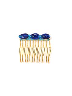 Get ready to party with our Beach Rave Hair Comb! Handpainted shells and intricate crochet threadwork add a touch of fun and whimsy to your hair. Perfect for music festivals, beach days, or everyday use. 1.75" Gold plated brass comb Blue threadwork Hand-painted shells Handmade in New York City and Puerto Rico. Due to the handmade nature of our products, some charms may vary in color and style or be replaced if unavailable. Please allow 5-7 business days for production. Rave Hair, Hair Charms, Intricate Crochet, Painted Shells, Blue Beach, Hair Rings, Music Festivals, Beach Days, Hair Comb