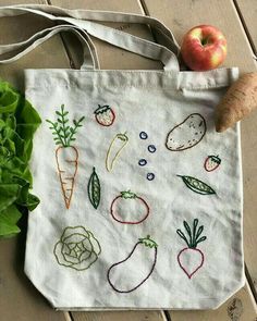 an embroidered bag with vegetables on it