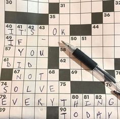 a crossword puzzle with a pen on it