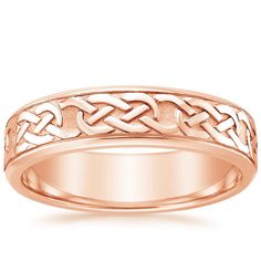 a wedding band with an intricate design in yellow gold