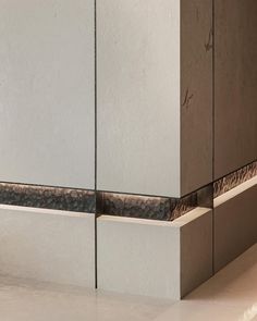 the corner of a wall with some tiles on it